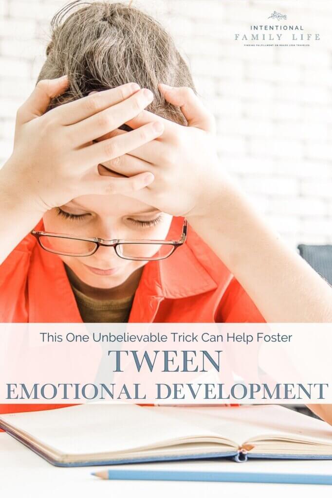 an image of a young child in school feeling frustrated at their desk with their head in their hands looking defeated - suggesting the concept of social and emotional development in tweens