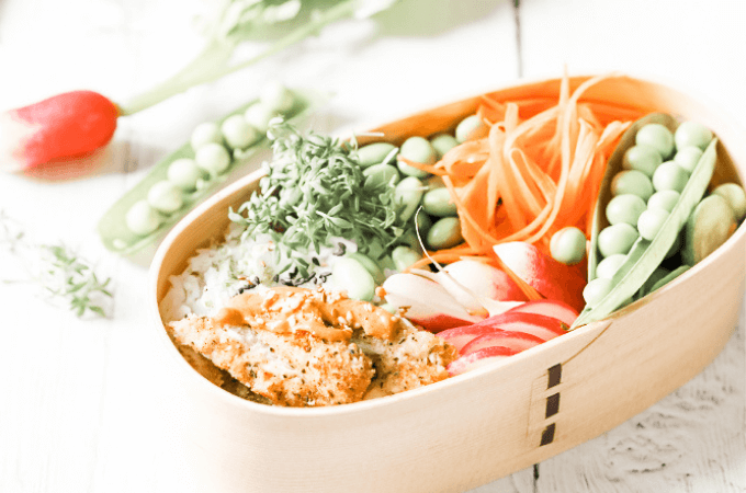 delicious looking bento box style lunch with chicken rice and vegetables