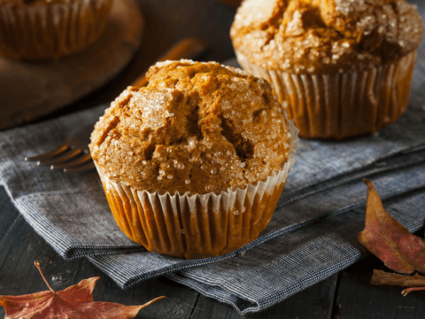 photo of a sweet potato muffin on gray cloth napkin with autumn leaves