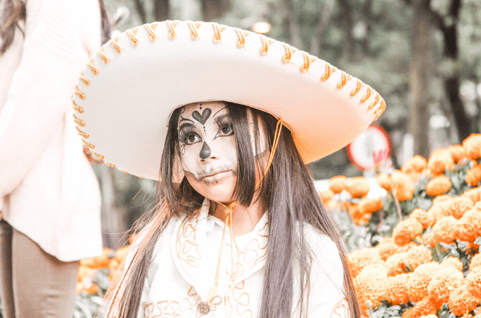 photo of young girl in dia del muertos makeup and sombrero - evocative of Mexican culture