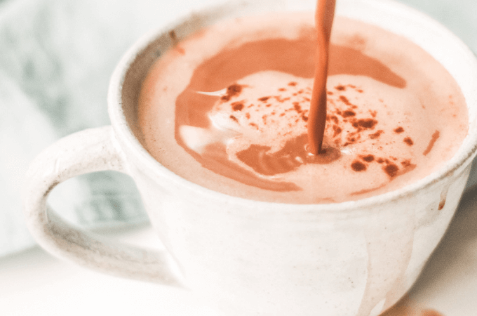 Image of a delicious looking cup of hot drinking chocolate being poured into a cup - warm with steam.