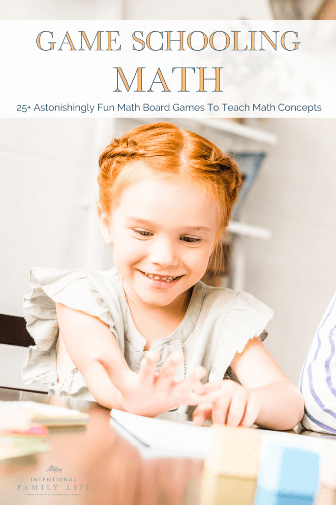 image of young girl playing math board game with manipulatives and smiling