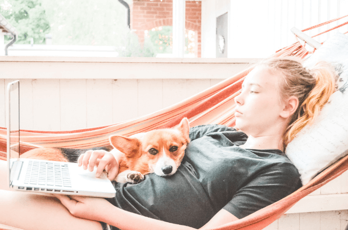 image of young girl in hammock with her dog - looking sad and lonely - suggesting the idea of school stress