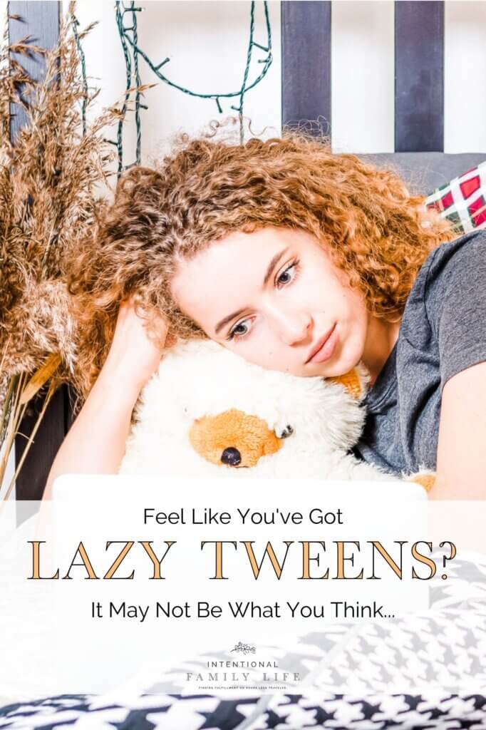 pretty young girl with curly hair laying on bed staring at computer screen suggesting stress management strategies