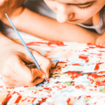 image of young girl painting a tween craft