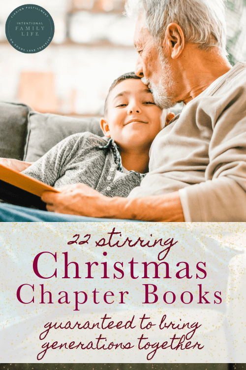 grandfather and grandson in a warm embrace on the sofa while reading a story together - suggesting holiday or Christmas chapter books